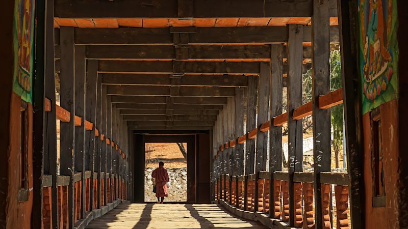 Monk walking towards Dzong, Paro, Bhutan