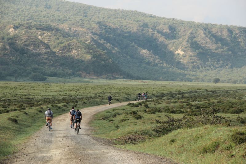 Cyclists ride bikes through Hell's Gate National Park in Kenya