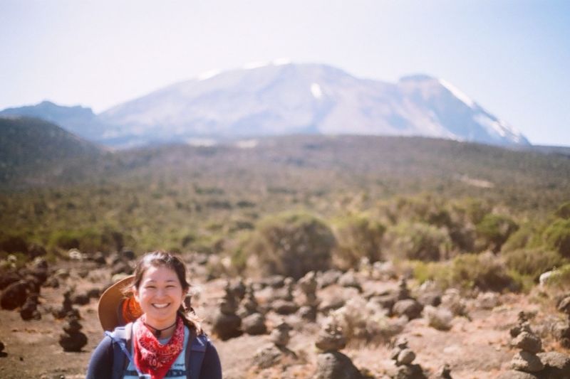 Woman smiling with Mt Kilimanjaro in background, August 2022