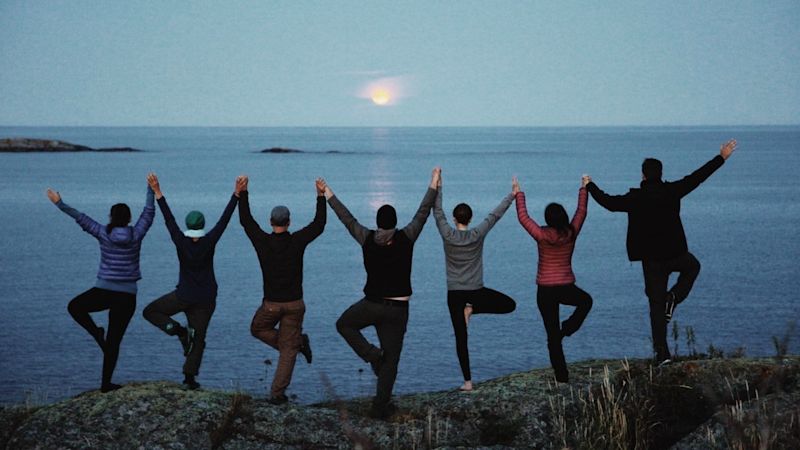 Sweden Group Posing for Picture in front of water kayak adventure