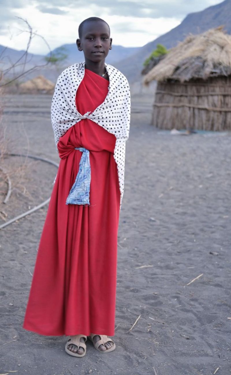 Maasai girl in long red dress