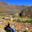 Young woman look at sacred valley in Ollantaytambo. Aerial view of ancient Inca city, Peru