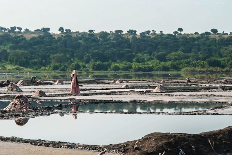 A local woman walks among the salt ponds of Lake Katwe in Uganda | Top 20 things to do in Uganda