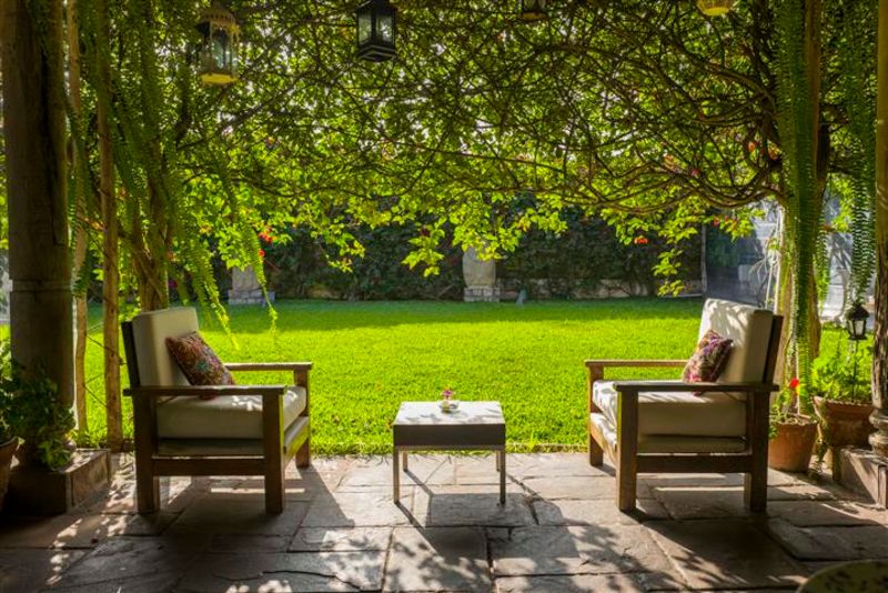 Two reclining chairs with garden behind at the Museo Larco cafe (image is theirs)