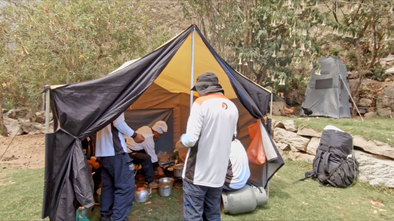 Follow Alice mountain crew by cooking tent on Inca Trail in Peru