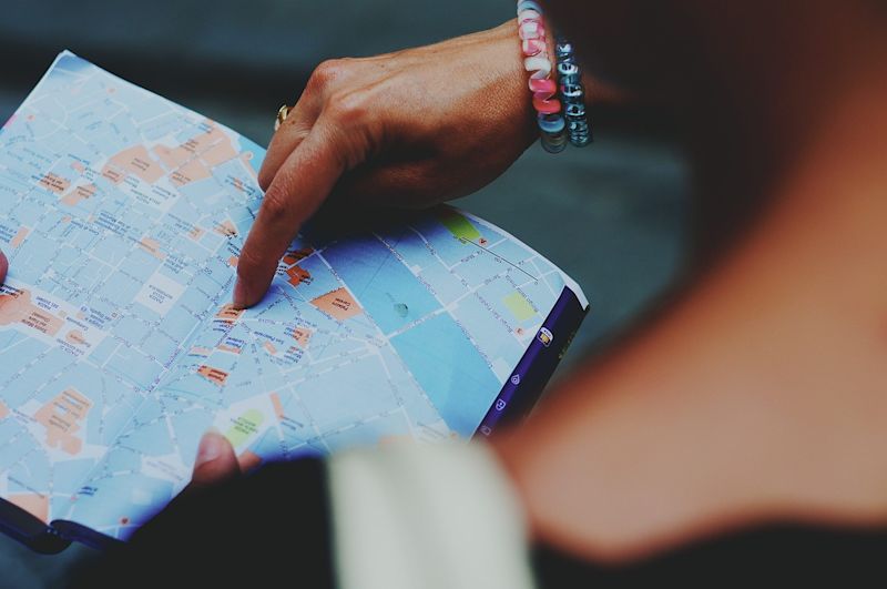 Woman pointing at a place on a map