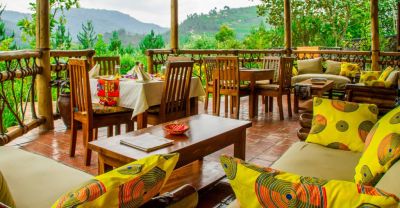 Ichumbi Gorilla Lodge dining area and lounge patio with view of Bwindi Forest, Uganda
