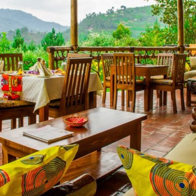 Ichumbi Gorilla Lodge dining area and lounge patio with view of Bwindi Forest, Uganda