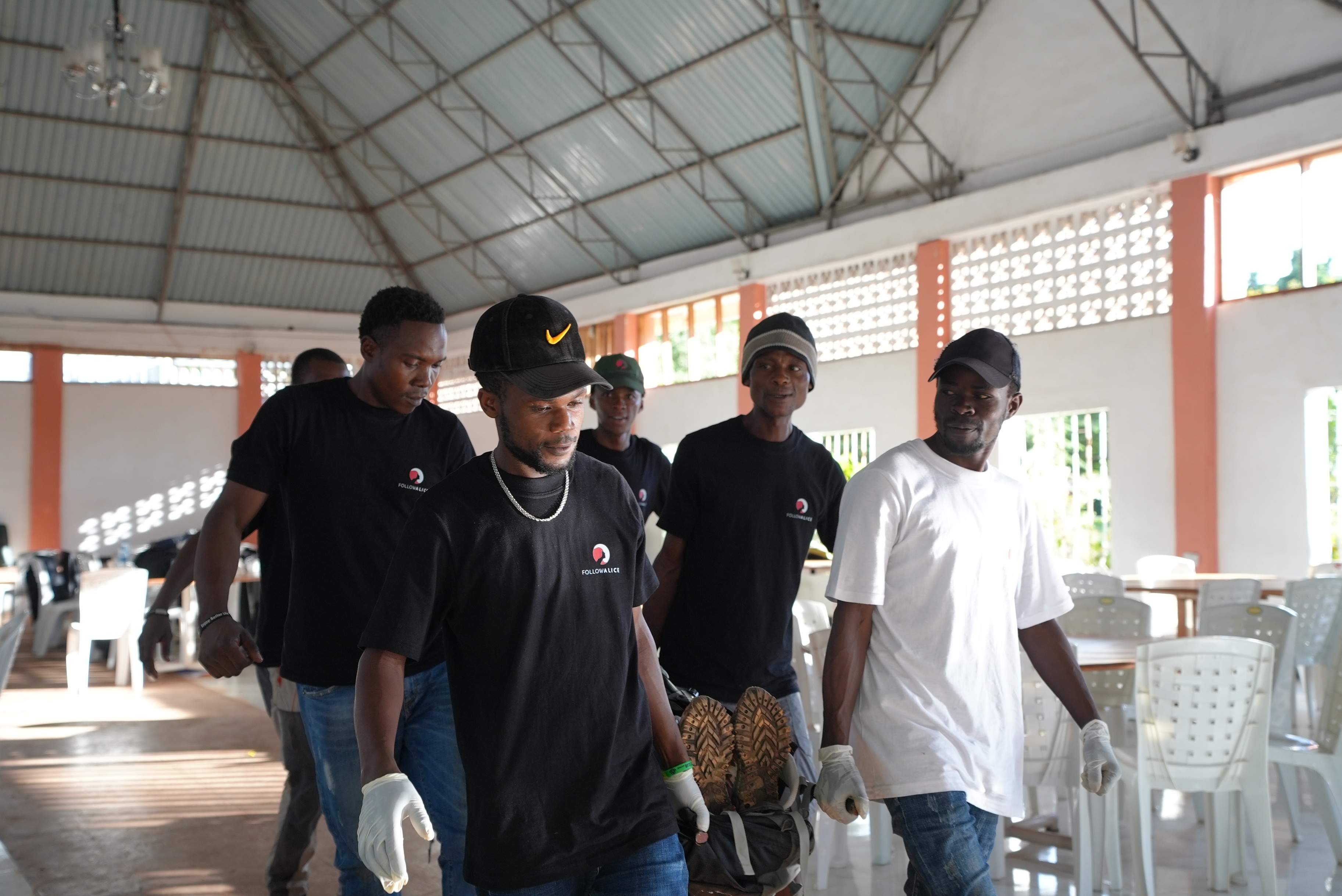 Men carrying a man on a stretcher
