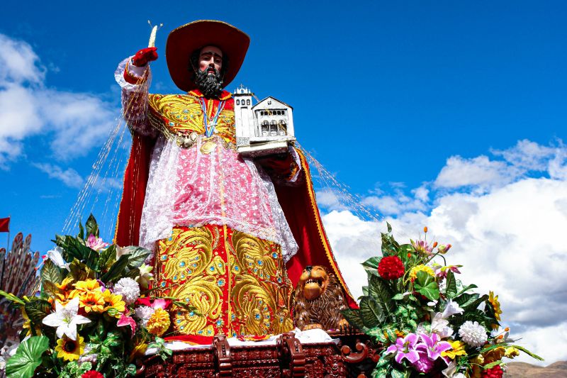Corpus Christi statue of church figure holding church building, Cusco, Peru festival