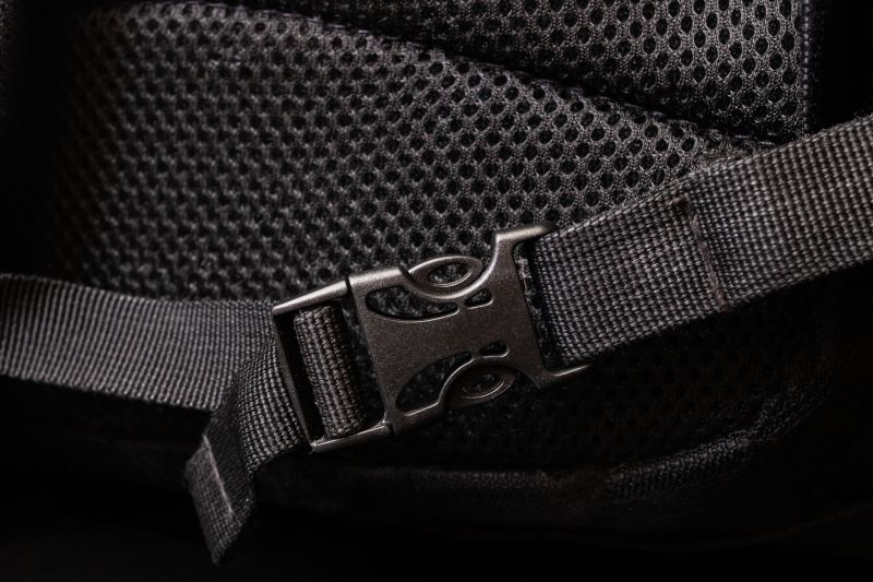 Close up of mesh and clasp on black backpack