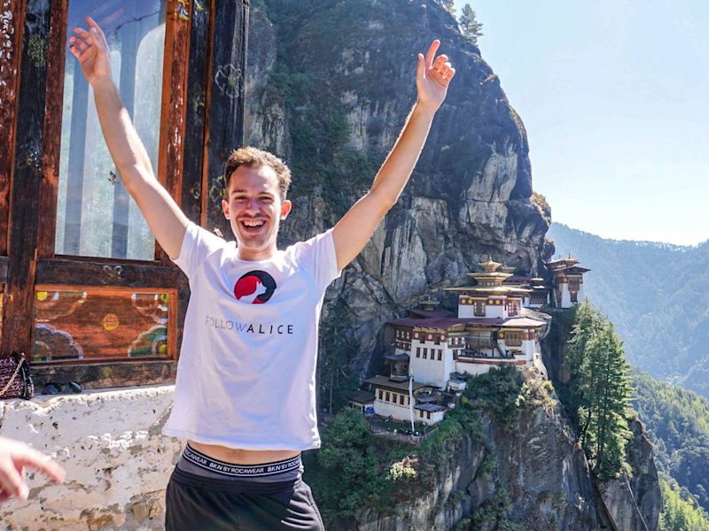 Happy man in front of Tiger's Nest Monastery