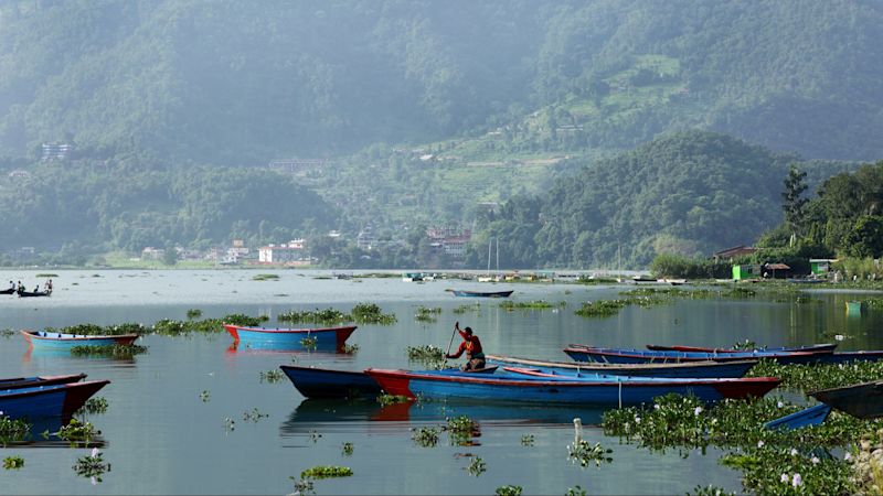 A boat woman taking out her boat in the vast Phewa Lake in August 2014 in Pokhara, Kathmandu, Nepal