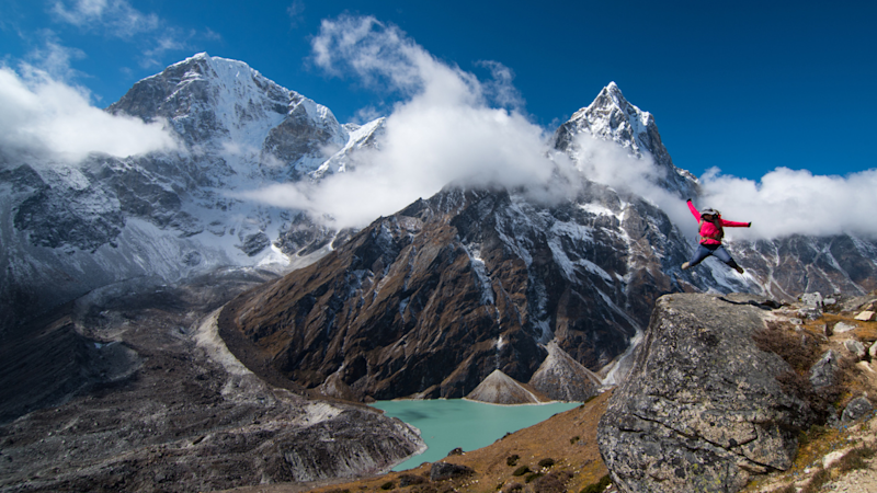 Hiker jumping in the air
