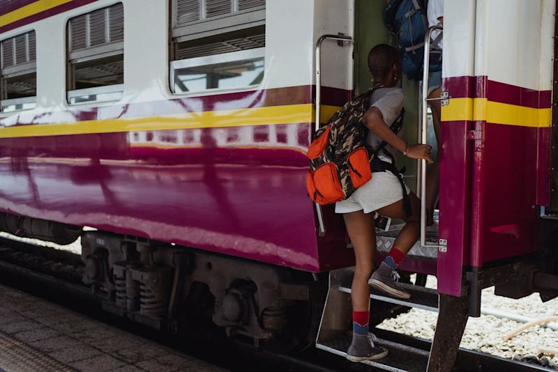 Woman traveller getting onto a train