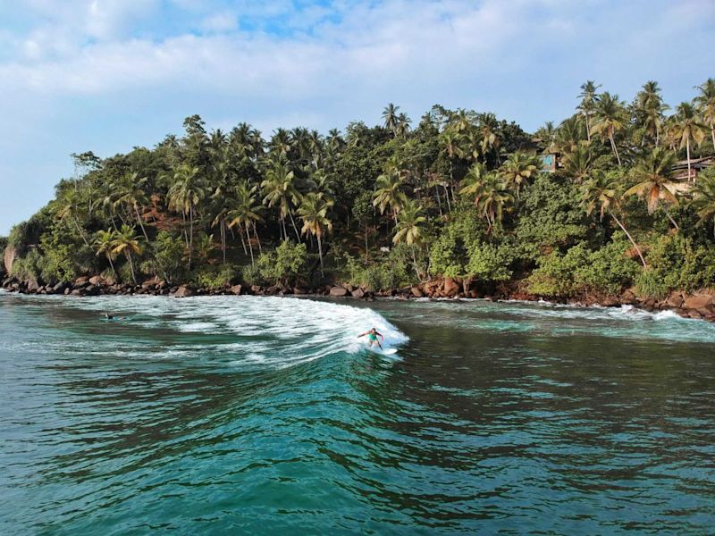 Surfer riding the waves of Sri Lanka