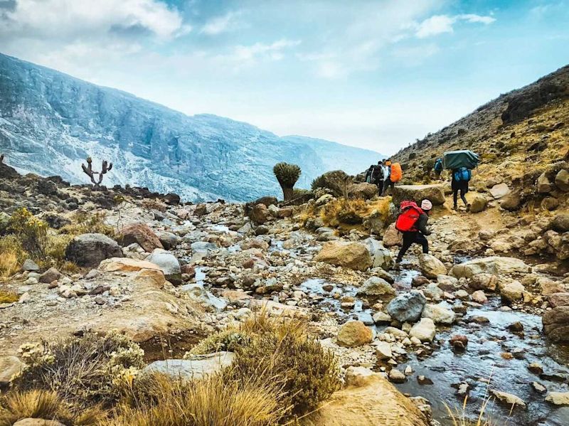 Kilimanjaro stream and scenery and trekkers