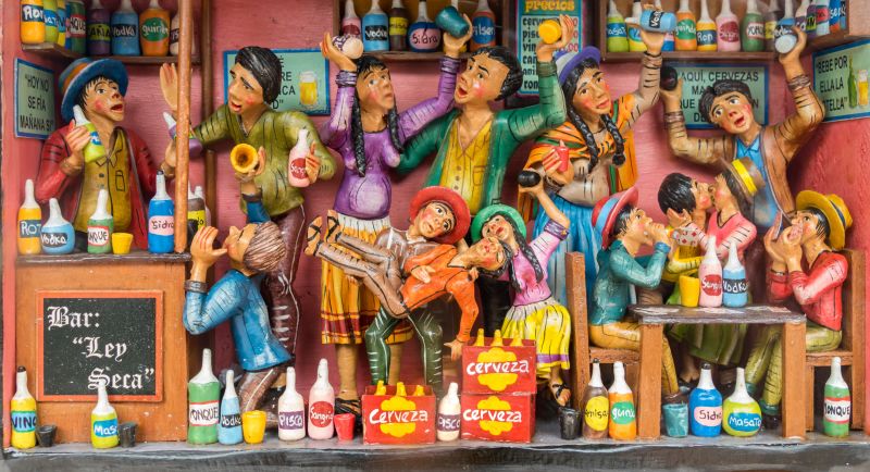 Colourful representation of statuettes of people, in Cusco, Peru, showing cerveza, which means beer 
