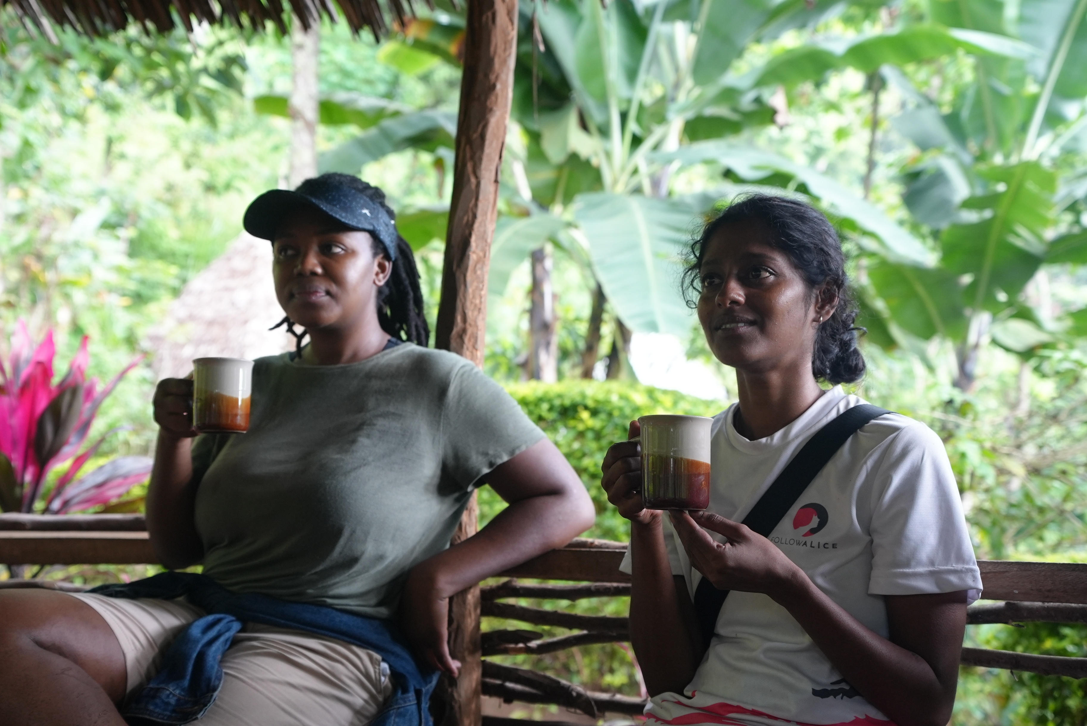 Two women drinking coffee at farm on slopes of Kilimanjaro