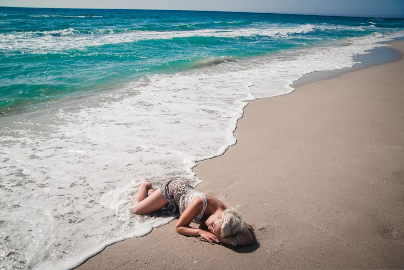 woman sleeping in the surf