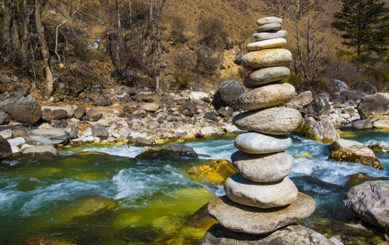 Stacked stones by river in Paro district, Bhutan