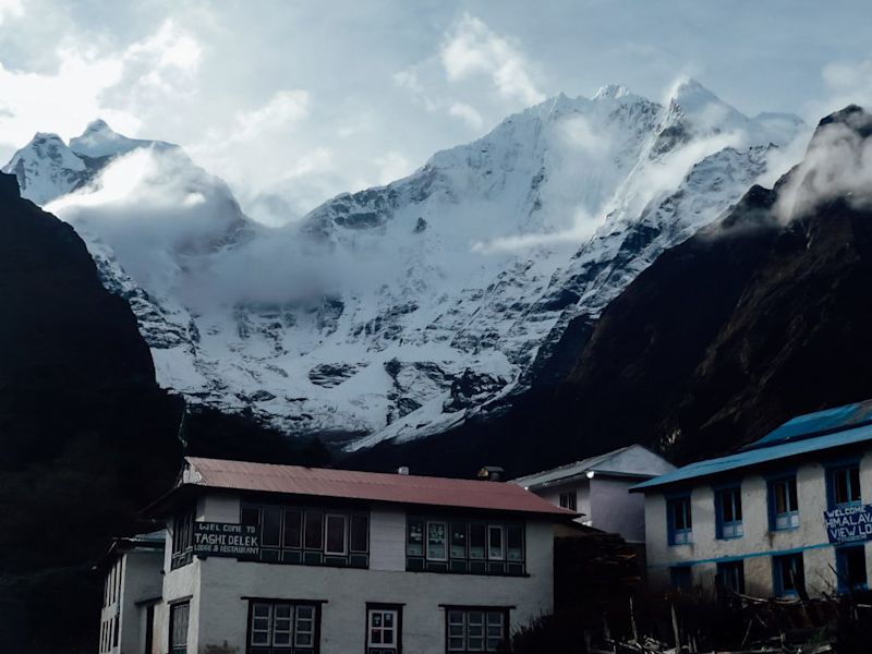 A teahouse surrounded by snow-peaked mountains on the Everest Base Camp trek, Everest Base Camp packing list