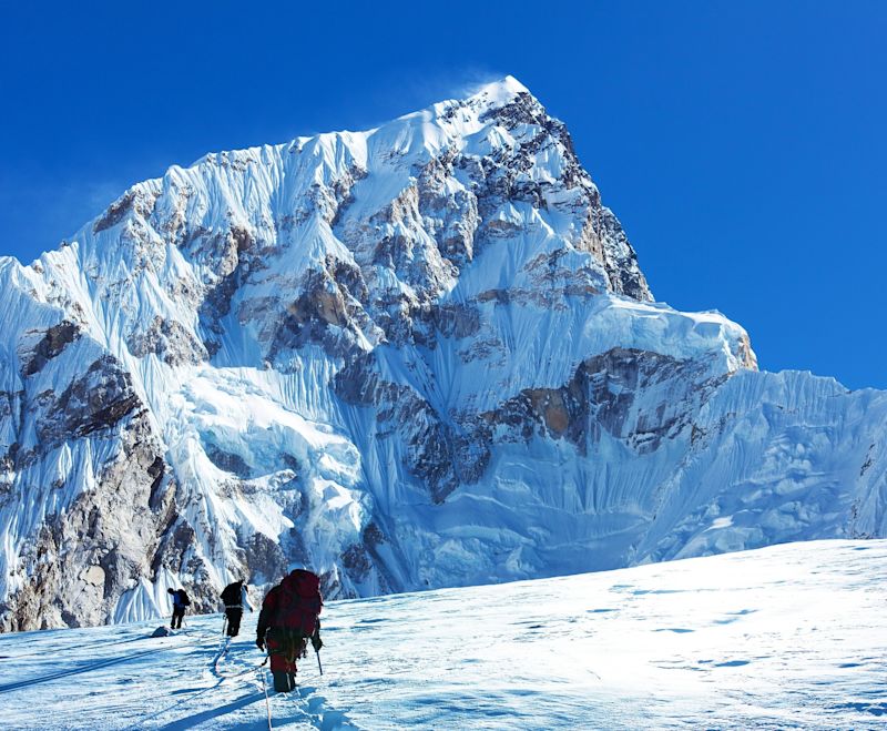 Montage of three hikers on glacier and mount Nuptse blue colored, Mt Everest area, Khumbu valley, way to mount Everest base camp, Nepal Himalayas mountains