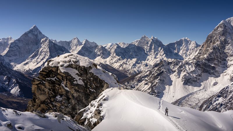 Trekker climber walking down from Lobuche East Peak