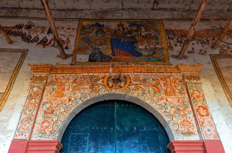 Entrance of the colonial church of Chinchero with its mural, Sacred Valley of the Inca, Cusco, Peru 