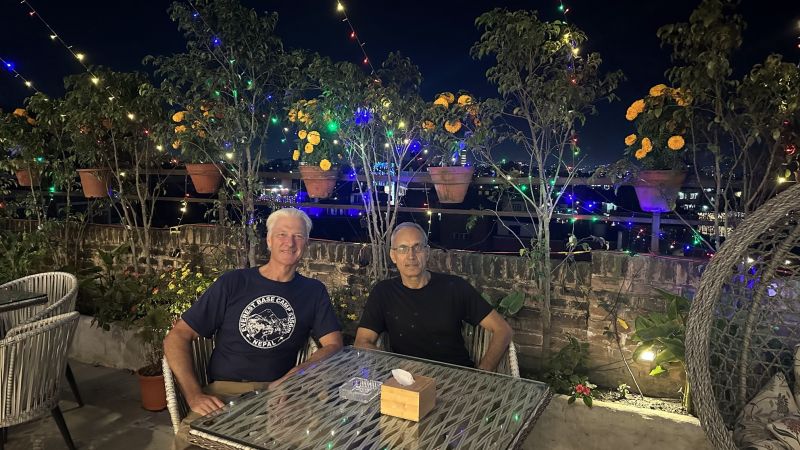 Two men at rooftop dinner in Kathmandu