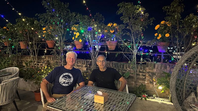 Two men at rooftop dinner in Kathmandu