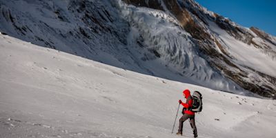 Trekker at the Thorung La pass - highesr point of Annapurna circuit in Nepal