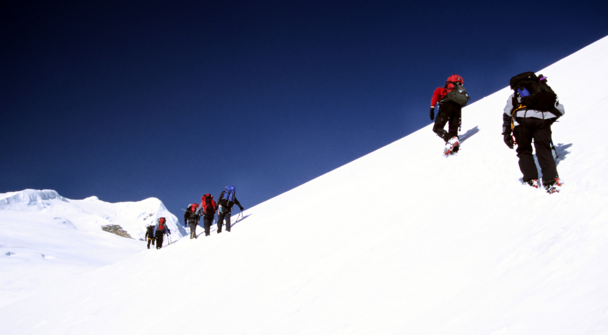 Climbing Mera Peak. Trekkers climbing from the Mera La, in the Himalayas on their way to summit Mera Peak