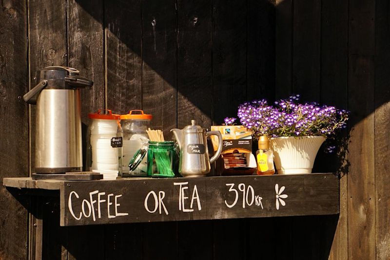 Sun shines on a ledge outside a shop with tea and coffee for sale in Reykjavík