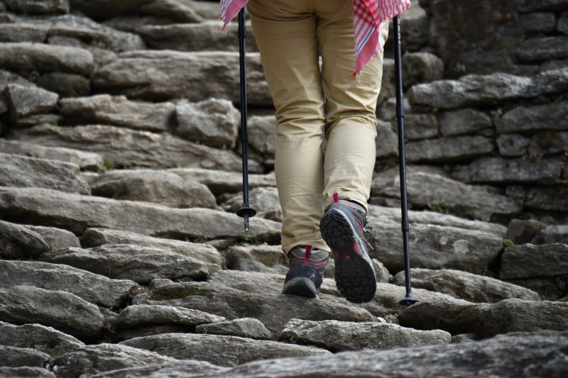 Female trekker walking up stone steps in Nepal