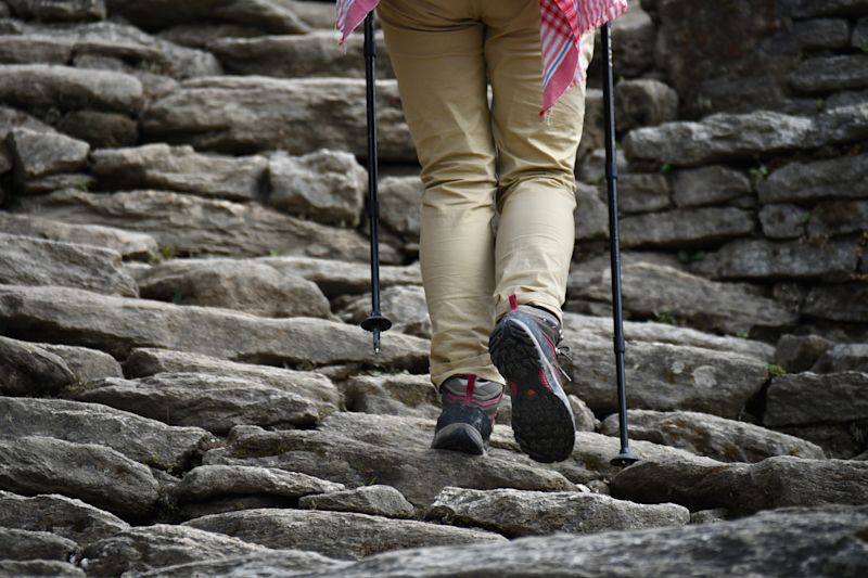 Female trekker walking up stone steps in Nepal