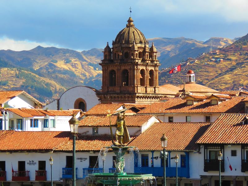 Cusco city church and homes with mountains in background, Peru