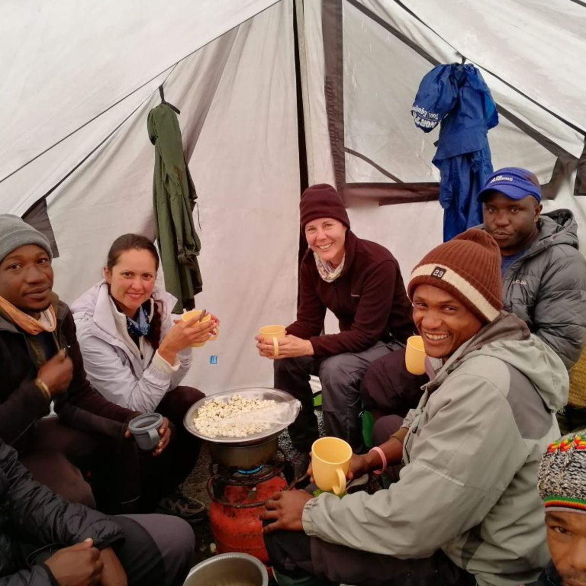 Climbers in the mess tent eating popcorn on Kilimanjaro