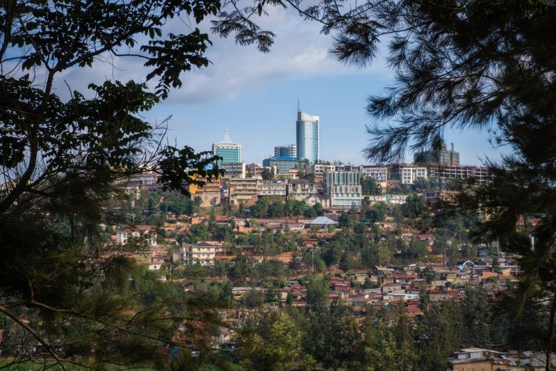 View through trees, of modern office buildings on a hill in Kigali city, Rwanda