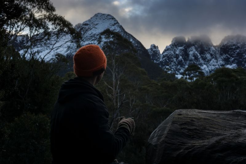 Sipping a warm drink on a cold morning in the mountains. Tasmania's Overland Track