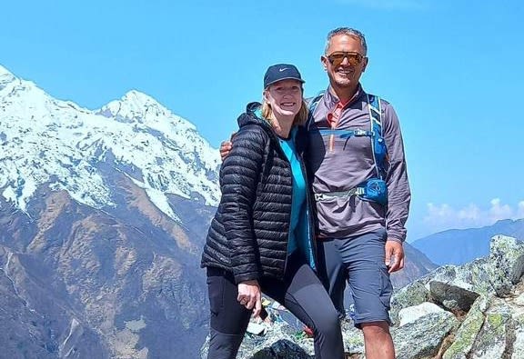 Bryan and Nikki smiling for camera on mountainside during Langtang Valley trek May 2023