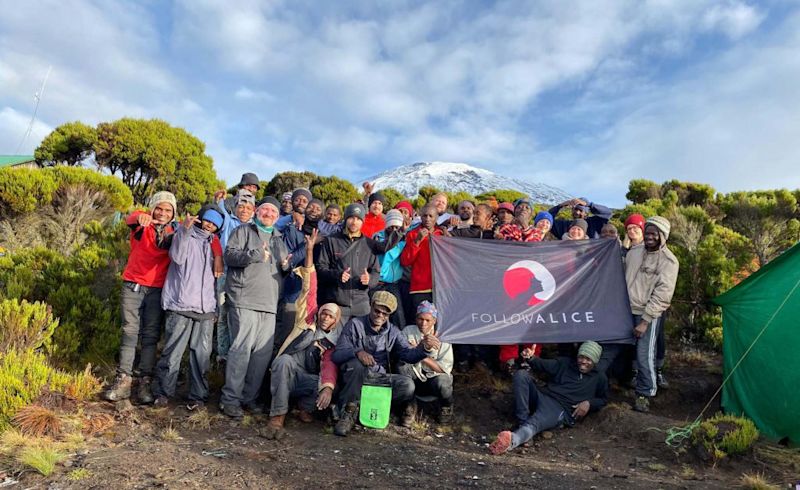 Group Picture Kilimanjaro Team Holding Flag