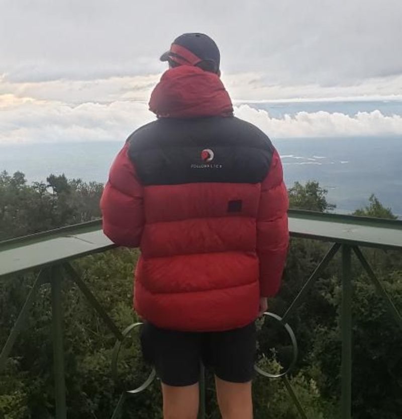 Man in red jacket facing away from camera on Mt Meru, Tanzania
