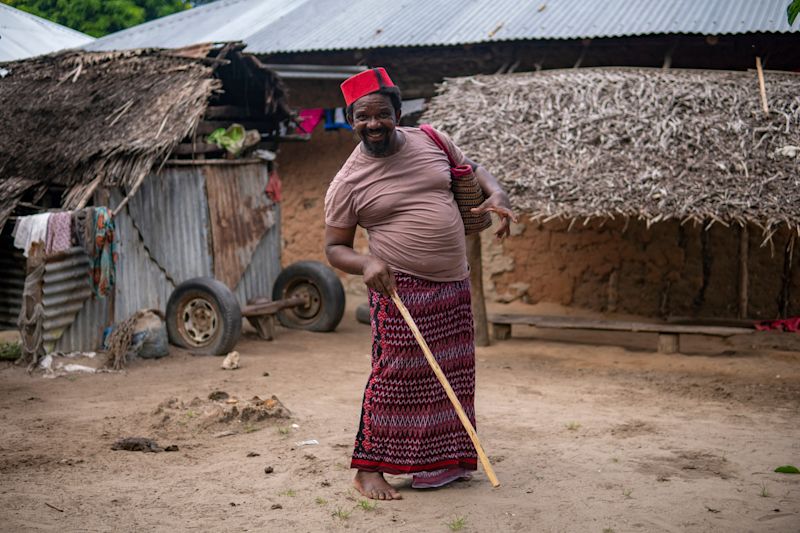 Older Man in Red Muslim Taqiyyah Fez Hat Near Hut in Remote Village in Pemba island