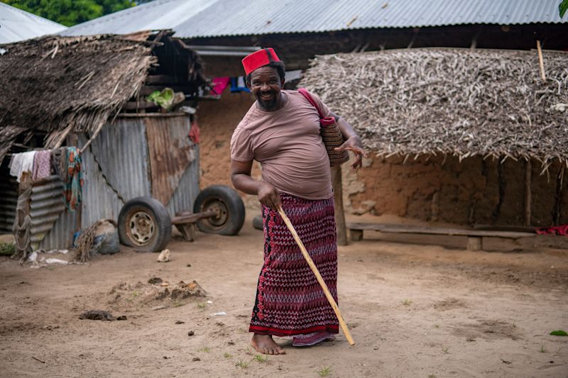 Older Man in Red Muslim Taqiyyah Fez Hat Near Hut in Remote Village in Pemba island 