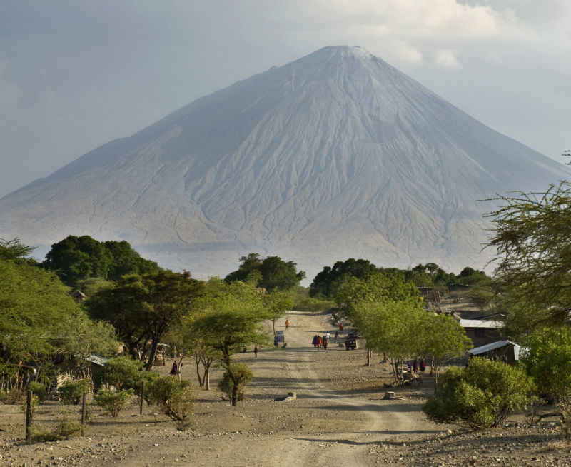 View of small village with Mt Ol Doinyo Lengai in background, Tanzania