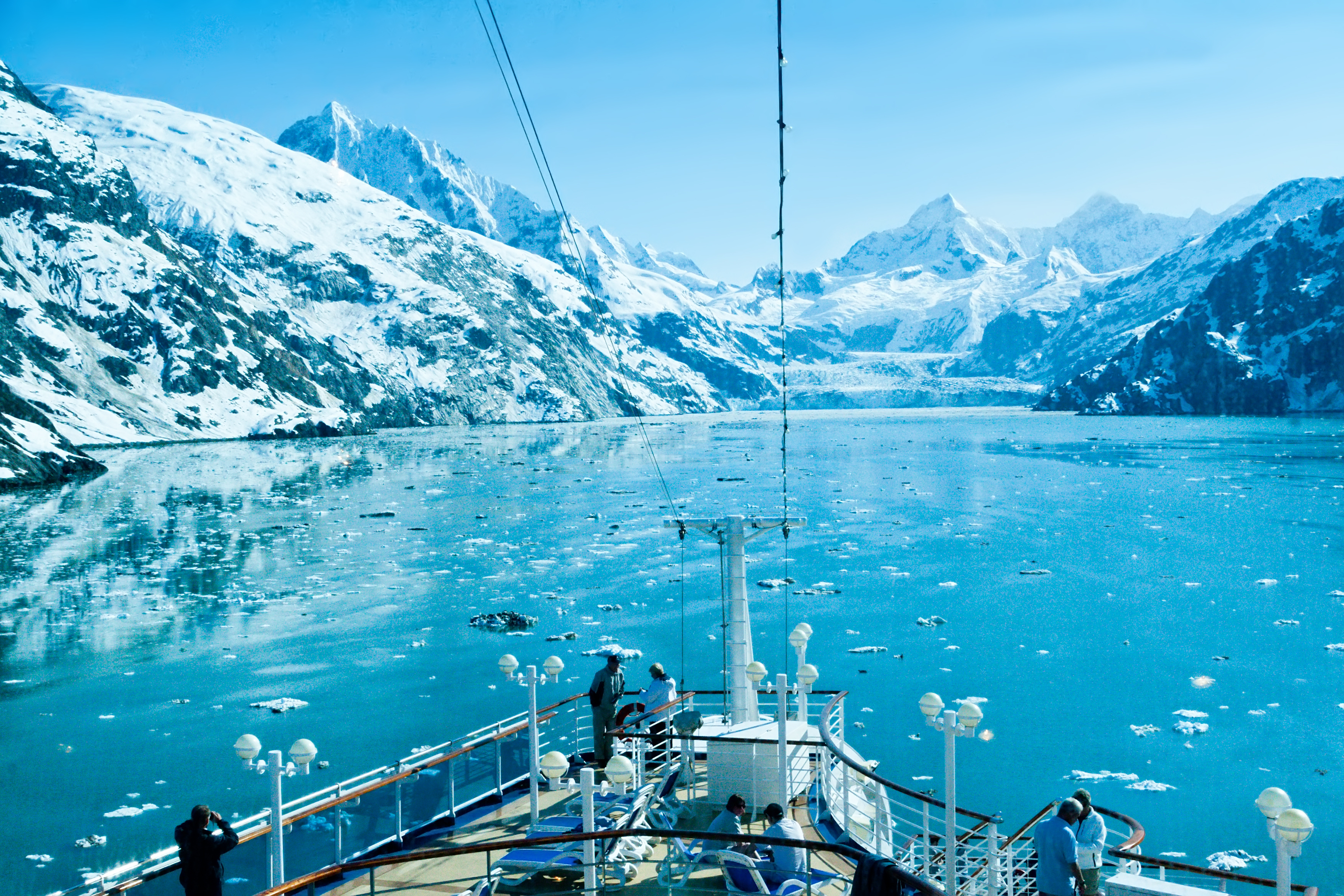 Passengers aboard a cruise ship enjoy the majestic view of one of Alaska s many beautiful glaciers.