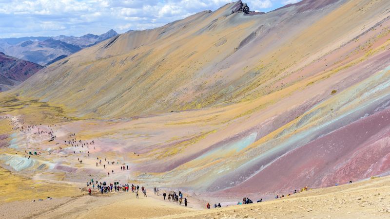 Long line of hikers starting the hike up Rainbow Mountain, Peru