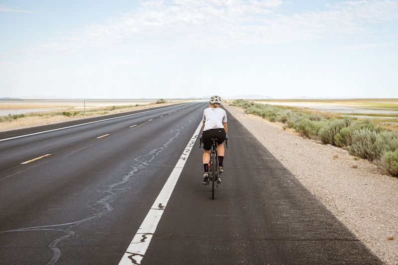 woman cyclist cycling on road