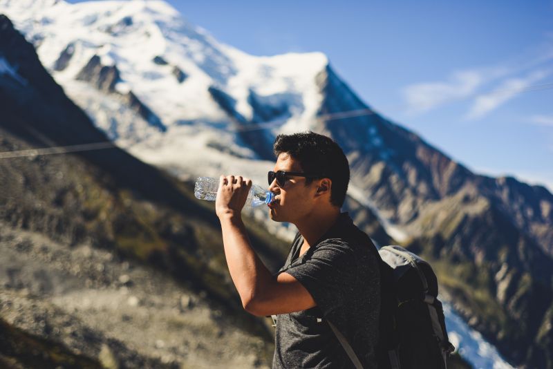 Male hiker drinking from water bottle